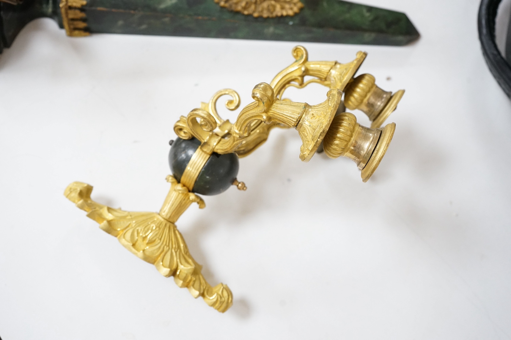 A simulated malachite wall sconce and a pair of ormolu three-branch wall lights, 55cm high. Condition - fair/good
